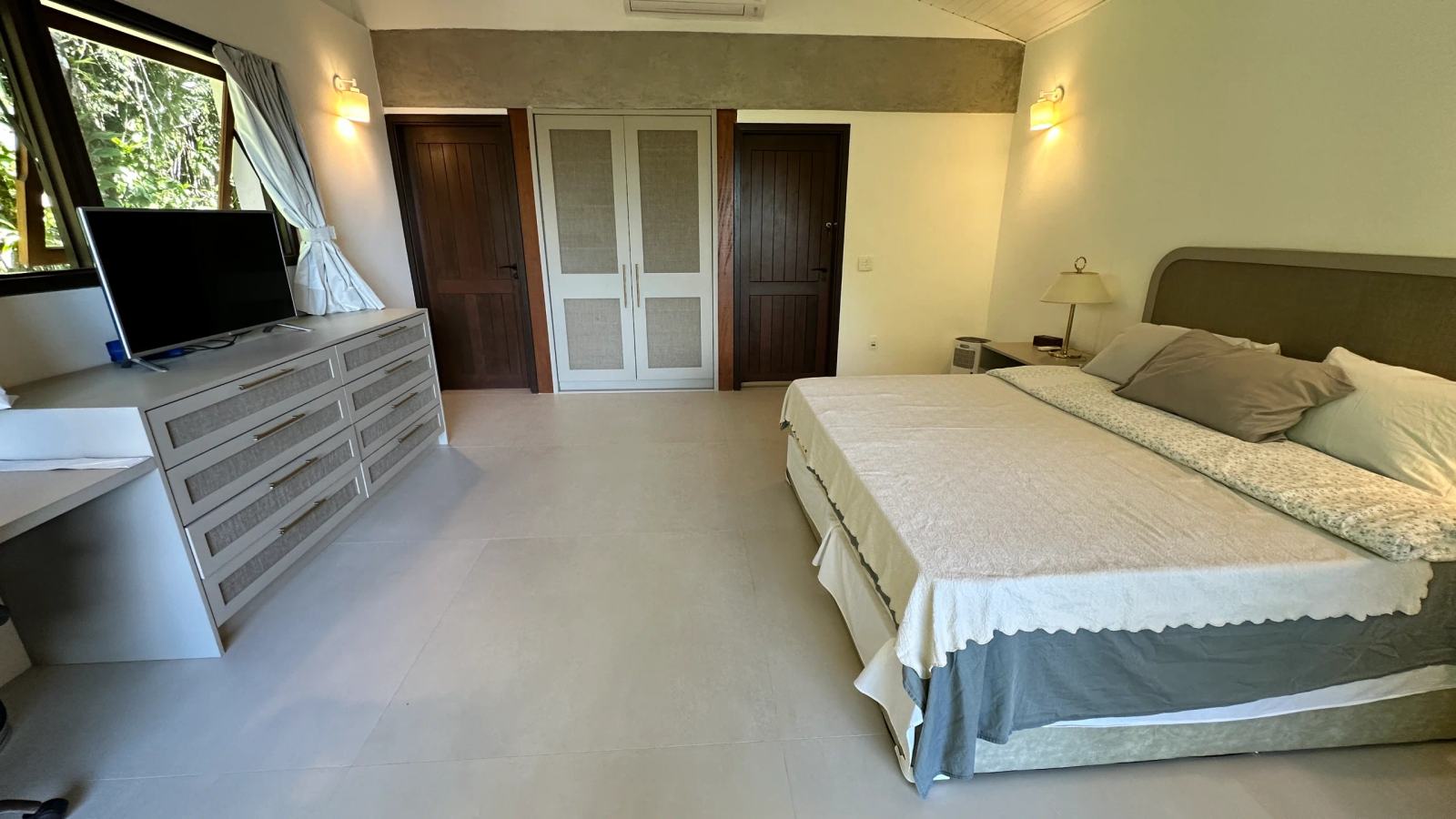 Villa 207 - Aluguel Temporada - Ambiente elegante da Suíte Master com cama king e mobiliário contemporâneo